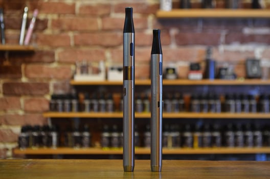 Electronic cigarette on a background of vape shop. E-cigarette for vaping. photo