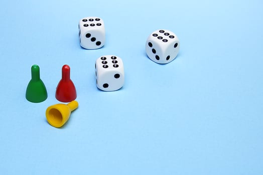 chips and dice for the game with the same number dropped on a blue background photo