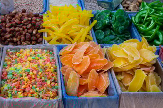 Dried fruits melon, pineapple, mango, kiwi, dates, pomelo,  set of dried fruits, Pile of candied slices in boxes on the market photo