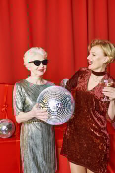 Stylish and fancy Caucasian senior and mature woman at the party with wine glasses Party, celebration, holidays concept photo