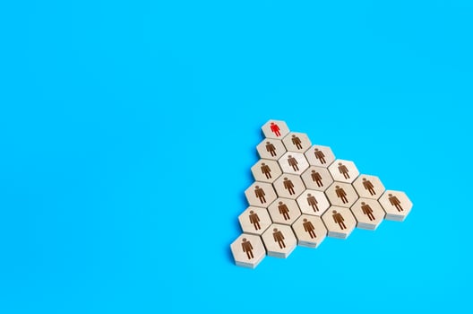 Leader at the head of hierarchical pyramid of the company. Traditional hierarchy concept. Superiors and subordinates. Meritocracy, corporate conformism. Personnel management. Cooperation and teamwork. photo