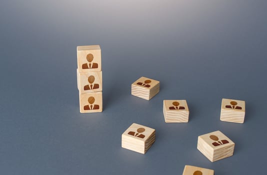 Figurine block tower with people. Hierarchical system. Company organization. Hiring, recruiting. Team building personnel leadership. Effective productive business employees group collectives. photo