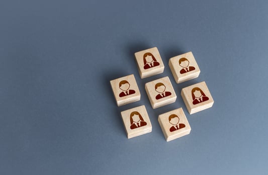 An ordered set of people on blocks. Combining to achieve a goal. Unity. Teamwork cooperation. Autonomy performance. Business personnel management. Team building. Recruiting human resources photo