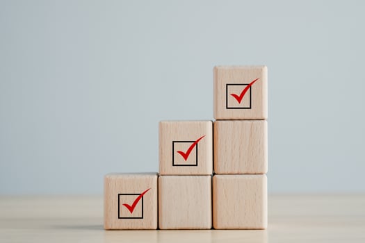 Checklist, Task list, Survey and assessment, Quality Control, Goals achievement and business success. Elections and Voting, Vote, to do list, Red check mark on stack of wooden block. photo