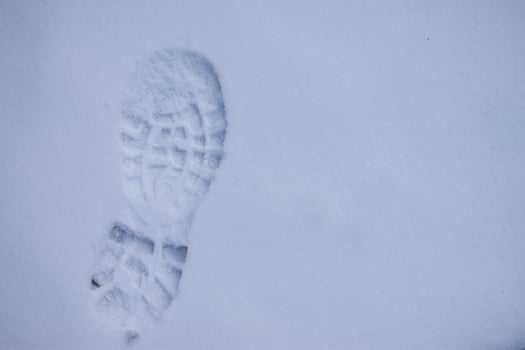 footprint of a hiking boot on the virgin snow photo