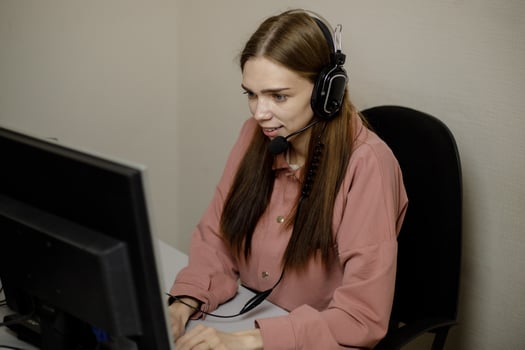 A happy call center agent working on a support hotline in the office. photo