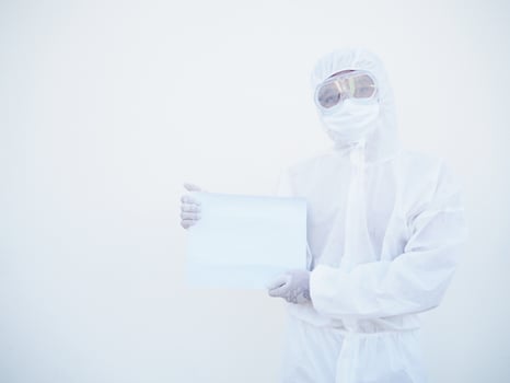Young doctor or scientist in PPE suite uniform holding blank paper for text with both hands While looking ahead. coronavirus or COVID-19 concept isolated white background photo