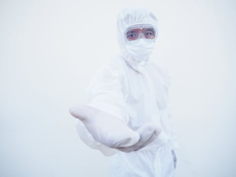 Asian doctor or scientist in PPE suite uniform offering handshake as greeting and welcoming. coronavirus or COVID-19 concept isolated white background photo