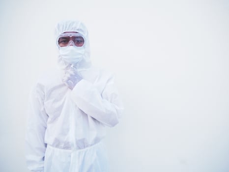 Portrait of confident asian male doctor or scientist in PPE suite uniform empty space deep thinking creative person hand on chin with looking ahead on white background. COVID-19 concept. photo