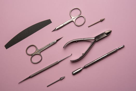 Set of manicure tools and accessories on a pink background. Hardware manicure,Flat lay. photo