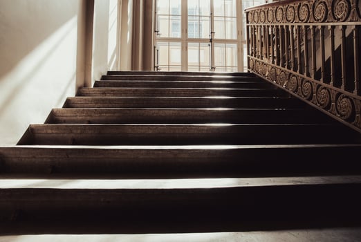 Old stone staircase lit with sun, way up, no people photo