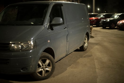 Transporter in parking lot at night. Van on street. photo