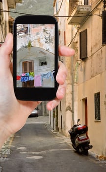 tourist taking photo of side street in town