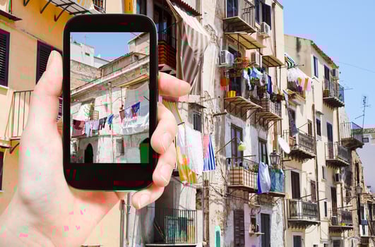 tourist taking photo of municipal house in Palermo