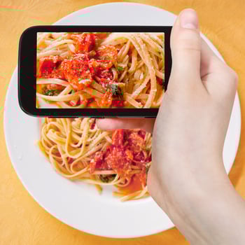 tourist taking photo spaghetti with tomato sauce