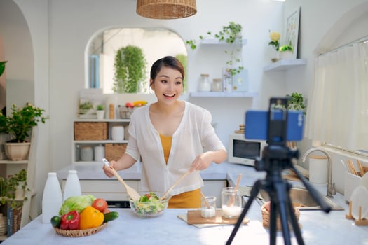 Asian woman recording a video blog photo