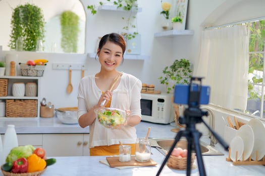 Asian woman recording a video blog photo