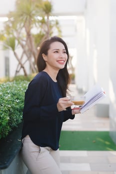 Young and pretty girl reading book on park in sunny day. photo