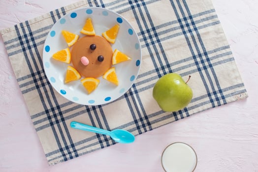 Pancakes with fruit for the children. Top view photo