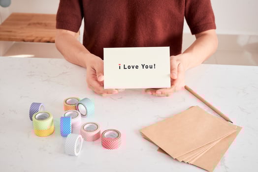 hands holding greeting card with phrase letters i love you prepared for sweetheart photo