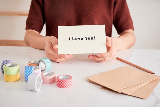hands holding greeting card with phrase letters i love you prepared for sweetheart photo