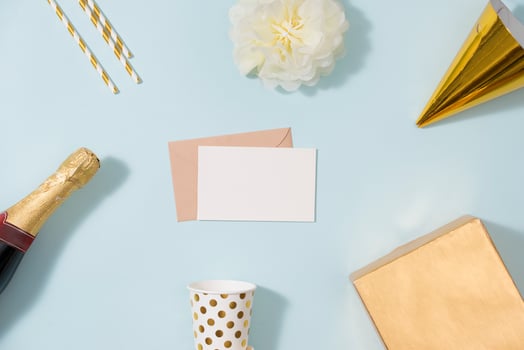 Flat lay Christmas or party background with gift boxs, champagne bottle, bows, decorations and wrapping paper in gold . Flat lay, top view photo