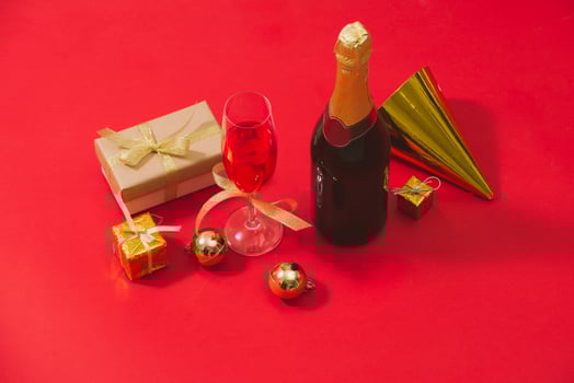 Champagne and Christmas ornaments on red table  background photo