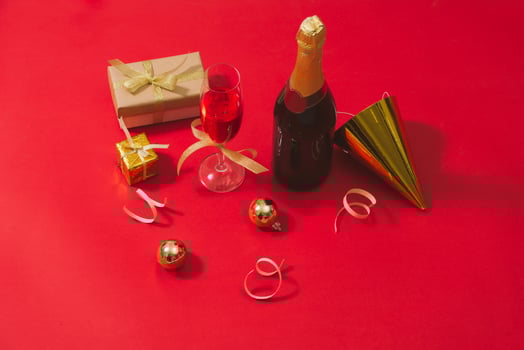 Champagne and Christmas ornaments on red table  background photo