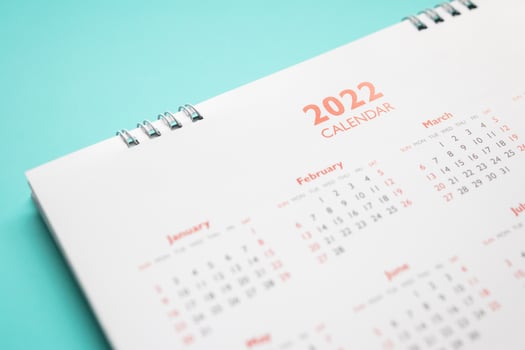 2022 calendar page on blue background business planning appointment meeting concept photo