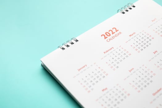 2022 calendar page on blue background business planning appointment meeting concept photo