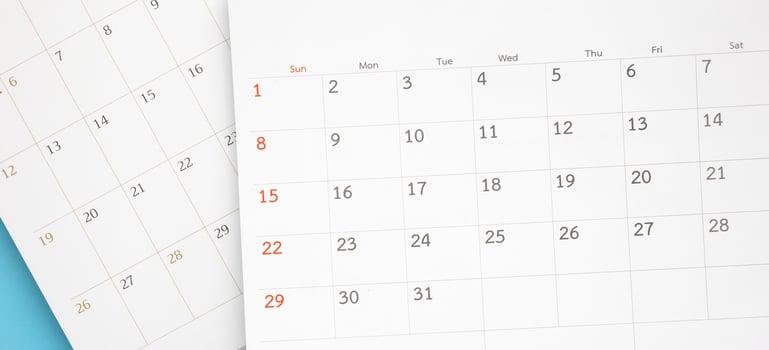 calendar page close up on blue background business planning appointment meeting concept photo