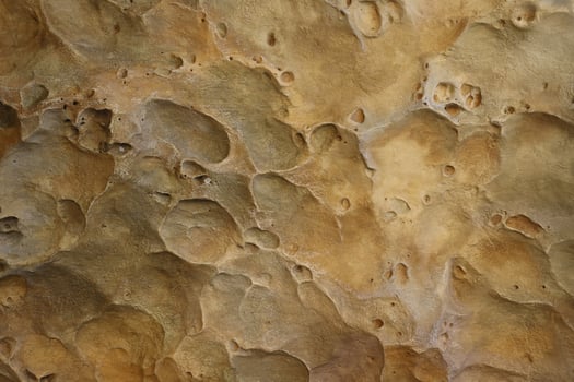 Combination of stone relief like a orange planet surface. Brown stone with abnormal relief shape photo