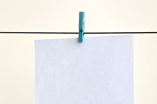 White blank cards on rope, light wall background. Creative reminder, small sheets of paper on old clothespin, memo backdrop photo