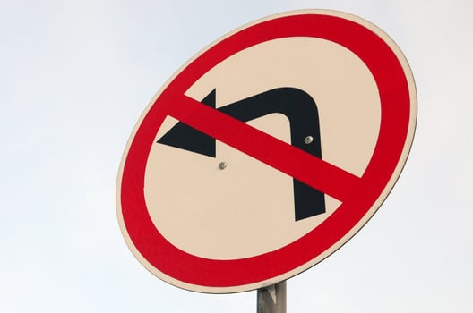 Turn left is prohibited. Traffic sign with crossed out arrow to the left photo
