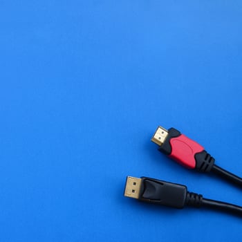 Audio video HDMI computer cable plug and 20-pin male DisplayPort gold plated connector for a flawless connection on a blue background photo