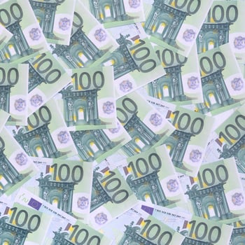 Background pattern of a set of green monetary denominations of 100 euros. A lot of money forms an infinite heap photo
