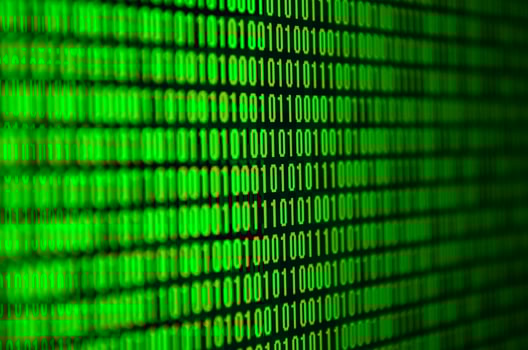 An image of a binary code made up of a set of green digits on a black background photo
