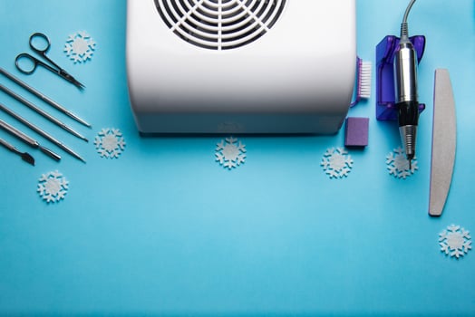 Top view of manicure and pedicure equipment on blue christmas background photo