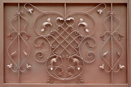 The texture of the bronze metal gate with a beautiful floral pattern of forged metal photo