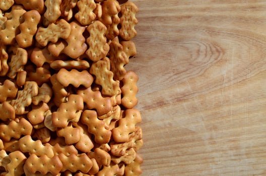 Many salted crackers on a cutting board with copy space photo