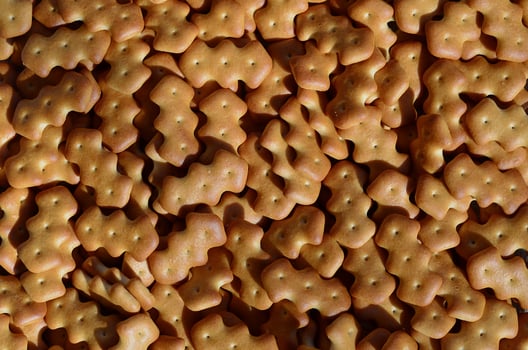 Pattern of a many yellow salted crackers photo