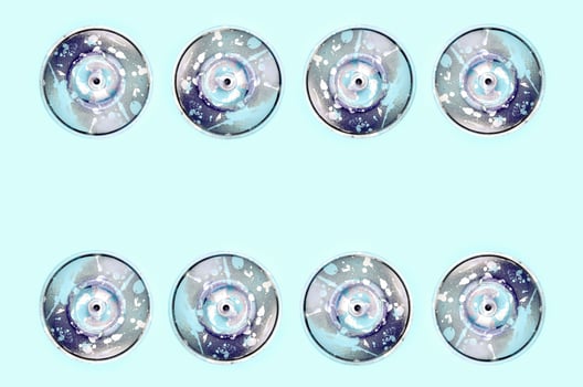 Many used spray cans for graffiti drawing lies on a pastel colored backgroung. Street art painting concept. Minimal flat lay pattern. Top view photo