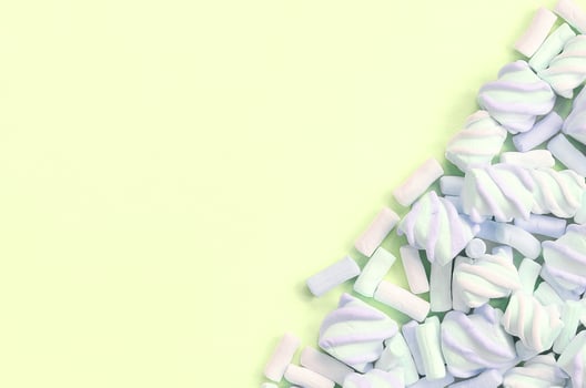 Colorful marshmallow laid out on lime paper background. pastel creative texture photo
