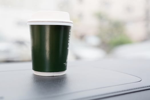 Eat a cup of coffee in the car during your commute to work. photo