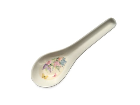 White spoon with a pattern of flowers on white background. Clipping path photo