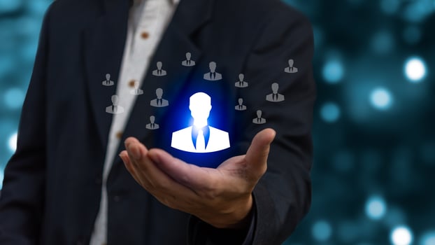 Magnifier glass focus to manager icon which is among staff icons for human development recruitment leadership and customer target group concept. photo