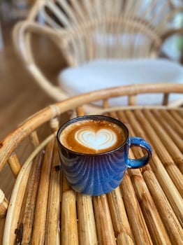 Heart latte art on coffee cup photo