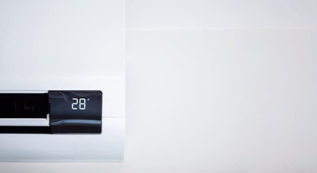 Air conditioner on white wall room interior background photo