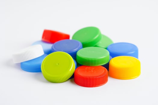 Plastic bottle caps colorful for recycle on white background. photo