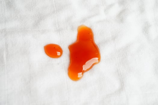 Dirty spicy sauce stain on cloth to wash with washing powder, cleaning housework concept. photo